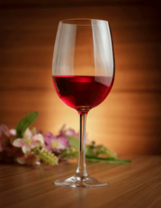 red Wine with blurred flowers in the background. 